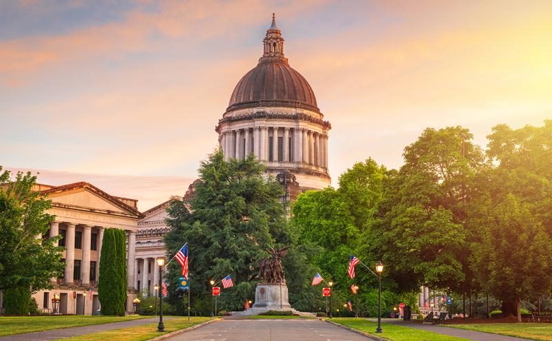 Washington state capitol building against a colorful sunset sky
