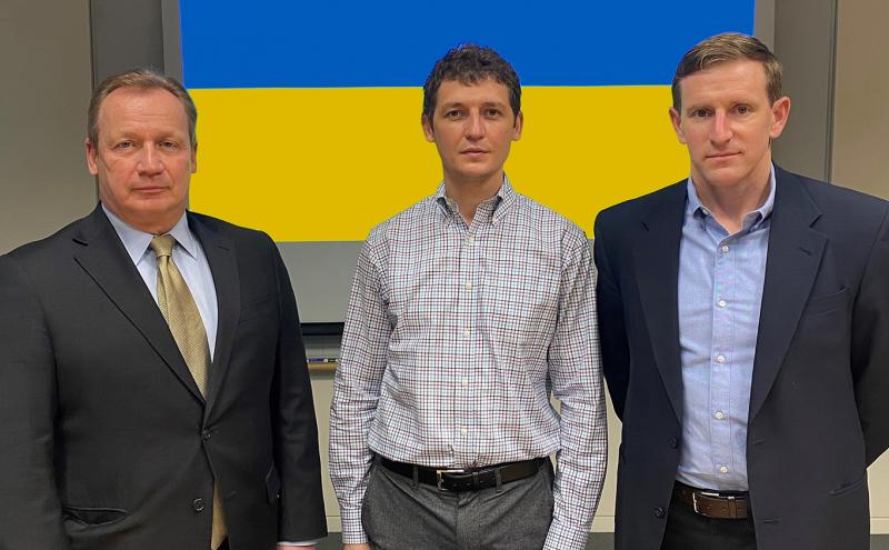 Steve Metruck–Port of Seattle Executive Director Valeriy V. Goloborodko–Honorary Consul of Ukraine and Ryan Calkins–Port of Seattle Commission President pose in front of a Ukranian flag at Port Headquarters