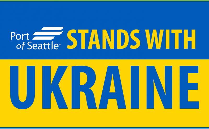 Port stands with Ukraine lettering atop the blue and yellow stripes of the Ukranian flag.