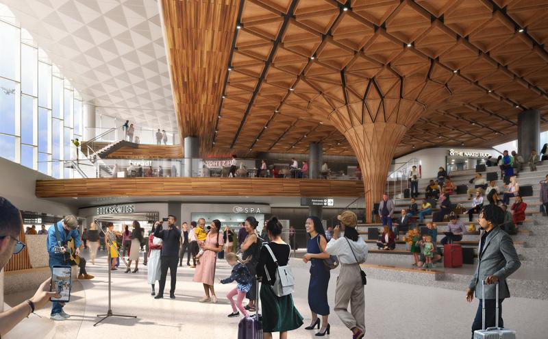 A spacious airport interior with a patterned wooden ceiling, multiple levels of shops and walkways, and travelers gathered near a musician in the open central area.