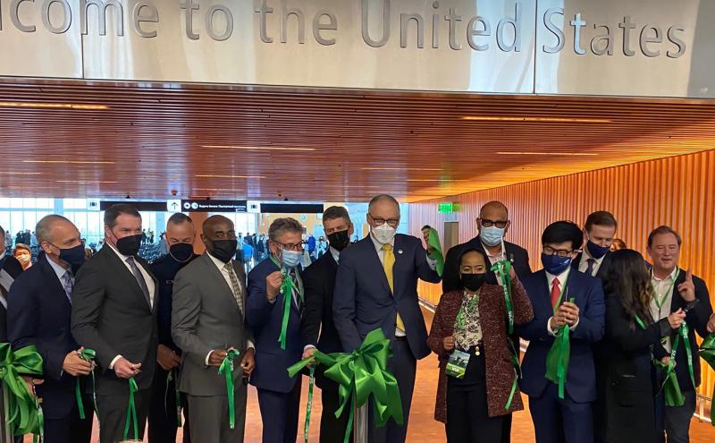 A cadre of leaders including Port Executive Director Metruck, SEA Managing Director Lyttle, Commissioners Felleman, Mohamed, Cho, and Calkins, and WA State Governor Inslee.