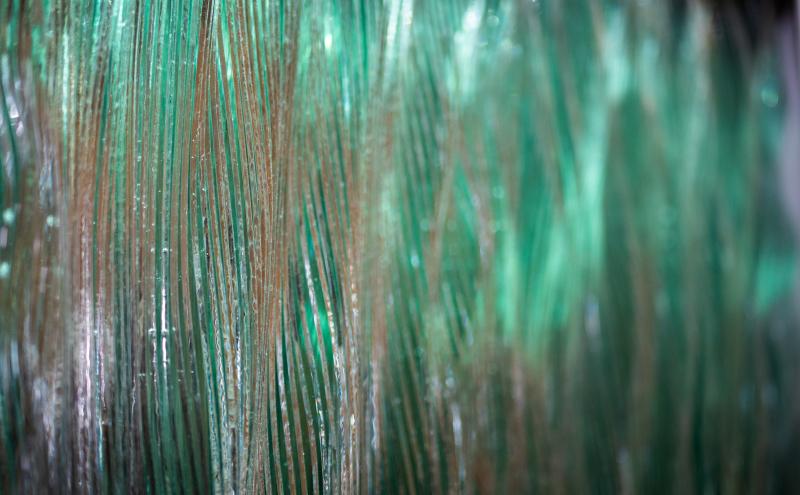 Close-up detail of the glass surface showing vertical waves. 
