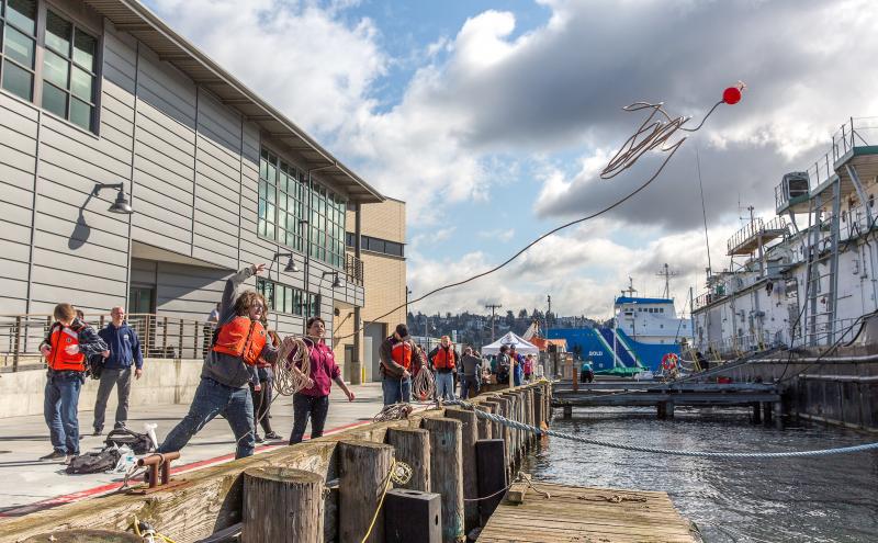 Maritime student throws a buoy at Seattle Maritime Academy