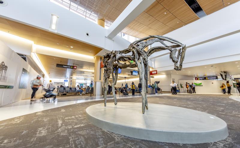 Wide angle view of the horse sculpture on it's platform in the center of the North Satellite concourse. 
