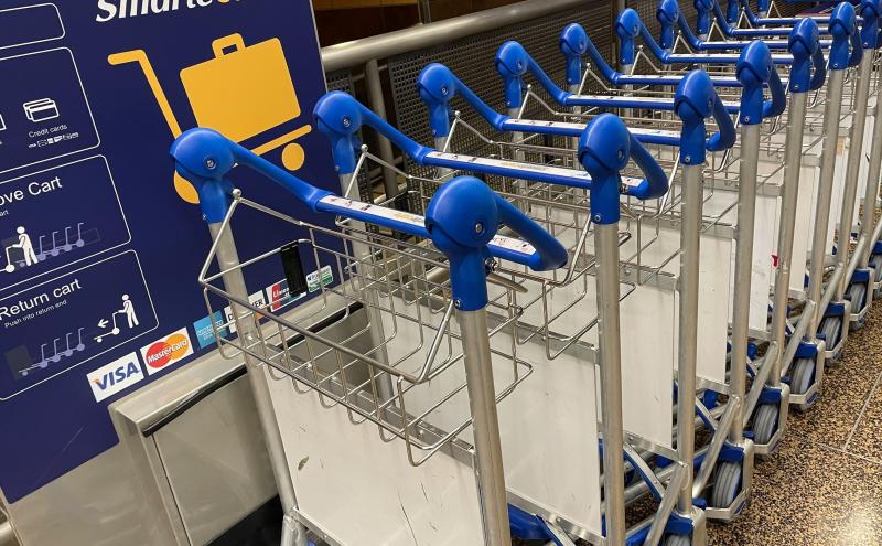 Luggage carts lined up and ready for travelers.