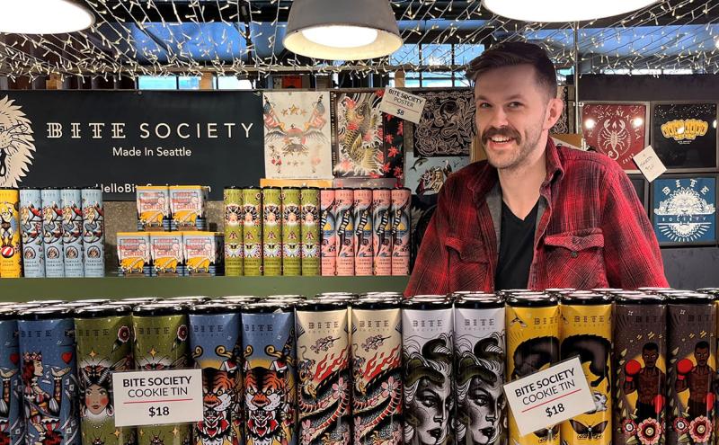 An employee behind the counter at Bite Society's Pike Place Market location