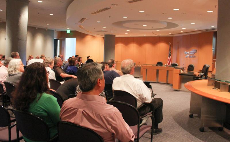 Audience members seated in rows facing a presentation area in a Port of Seattle meeting room.