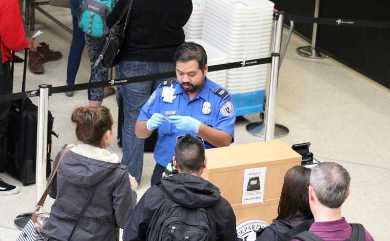 TSA agent checking IDs.