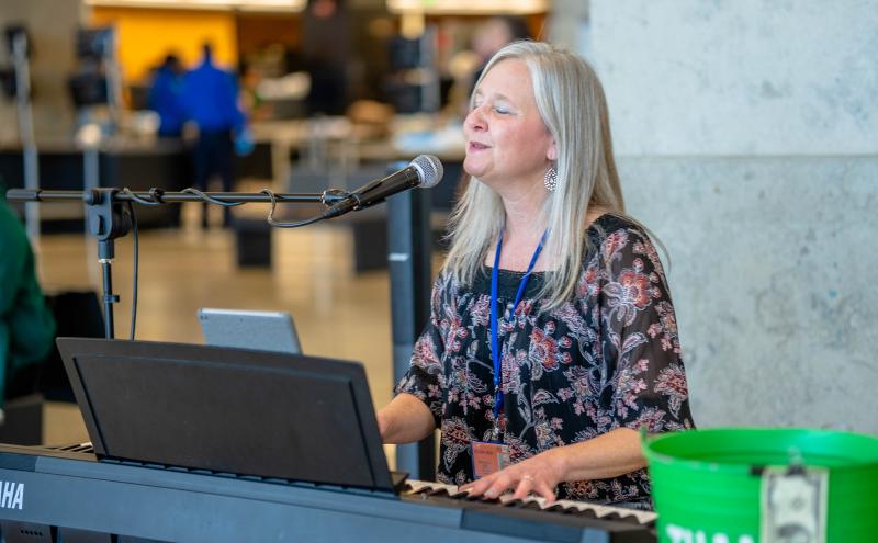 Cami Voss smiling and playing the piano at Central Terminal. 