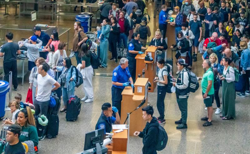 People traveling through TSA security checkpoints, SEA Airport
