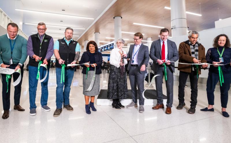 Representatives from the Port of Seattle, Alaska Airlines, and Hensel Phelps cut the ribbon at the SEA Gateway Project's Grand Opening recognition event