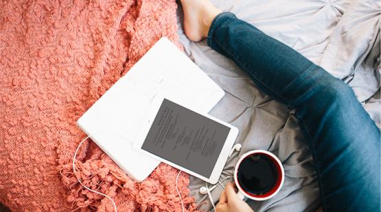 Person works on their resume in bed