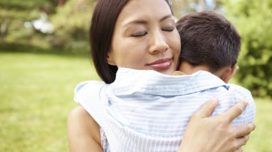 Mother and son hugging