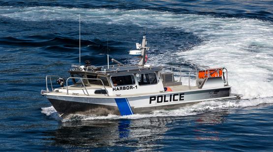A police boat driving through water.