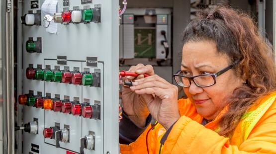 Shannon Acena-Neal inspecting an electrical box.