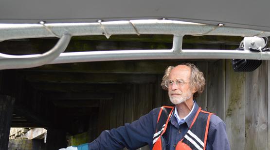 George Blomberg looks pensively out to sea on a boat en route to Smith Cove