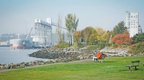 People sitting on a bench at Centennial Park.