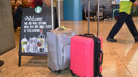 Suitcases in front of a Starbucks store.