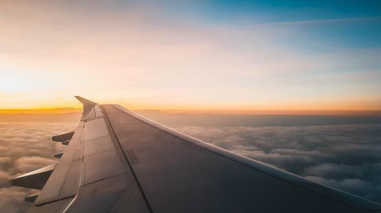 View of an airplane wing at sunrise