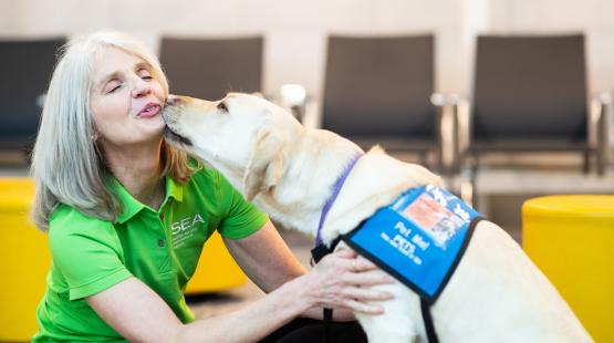 Airport volunteer Joanne Montzingo and therapy dog Gracie.