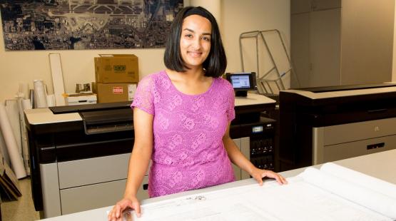 Woman looking at blueprints.