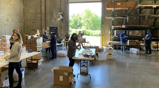 Port employees prepare face coverings for distribution.
