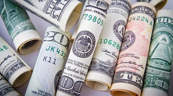 American currency rolled up.