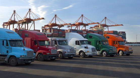 Trucks at a shipping yard.