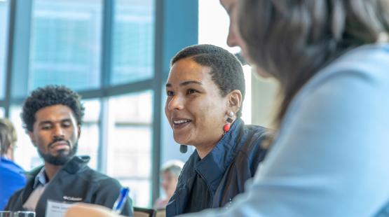 Zoomed in image of three participants talking during a round-table discussion.