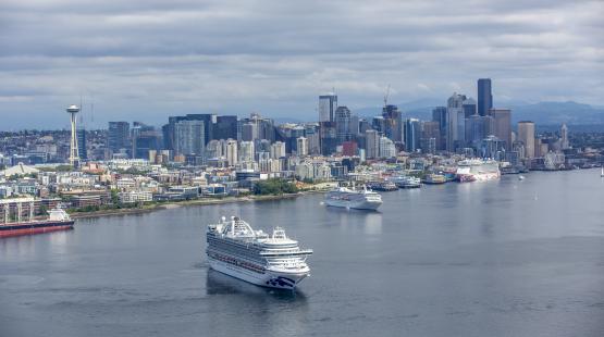 Cruise ship leaving the Port of Seattle with the city skyline in the background. 