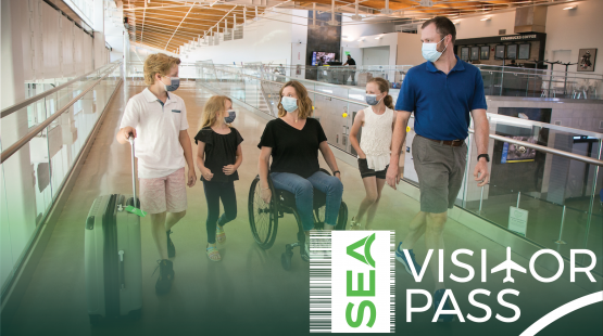 A family in masks at the airport with the SEA Visitor Pass Logo