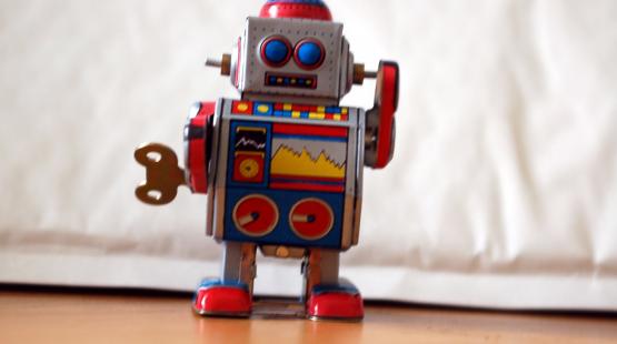 Red tin vintage toy robot with wind up key
