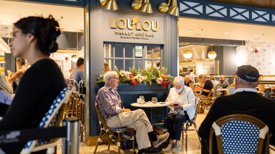 A photo of LouLou Market and Bar; travelers are sitting at tables and dining
