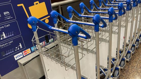 Luggage carts lined up and ready for travelers.