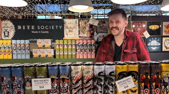 An employee behind the counter at Bite Society's Pike Place Market location