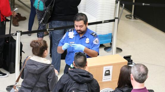 TSA agent checking IDs.