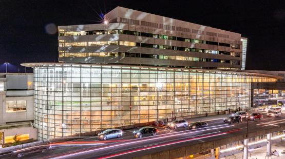 SEA Airport Office Building lit up at night.