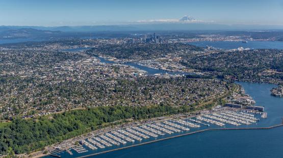 An aerial photo of Shilshole Bay Marina from the northwest. The ship canal, Elliott Bay, downtown Seattle, and Mount Rainier are visible in the distance..