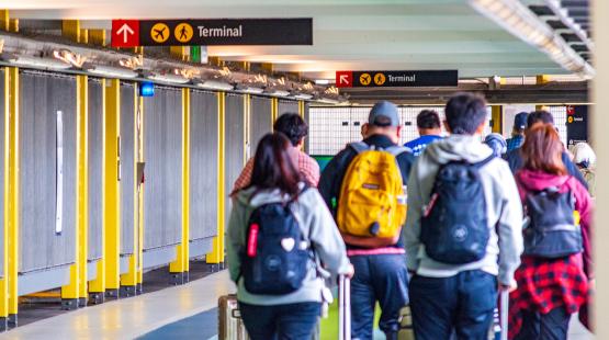 Passengers walk from SEA to the Link light rail station