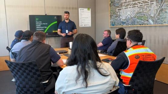 Airport Operations Orientation with Stakeholder Managers presentation in conference room.