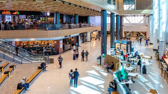 View inside the C Concourse Expansion showing Chili's, Nanny's, and retail kiosks.